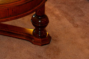 wall-to-wall carpet and coffee table leg